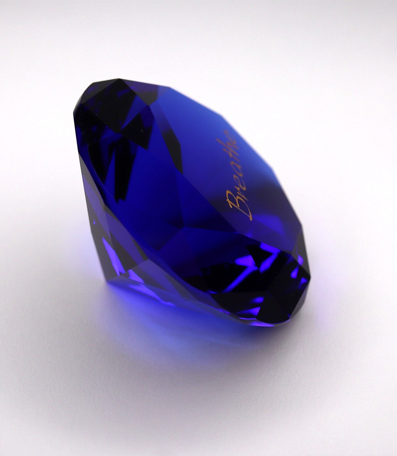 Sapphire Blue Paperweight – Weight: 4.3 oz – Measures 2 3/8″ – Text: Breathe