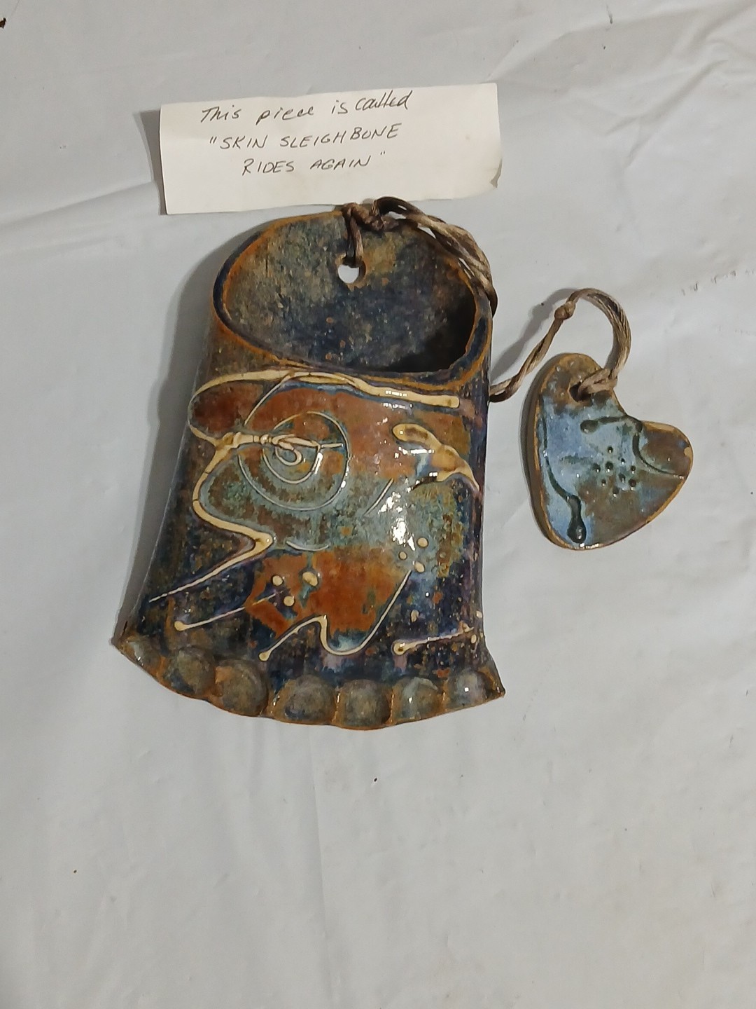 Art Pottery Wall Pocket W/attached Heart Called “Skin Sleigh bone rides again.”