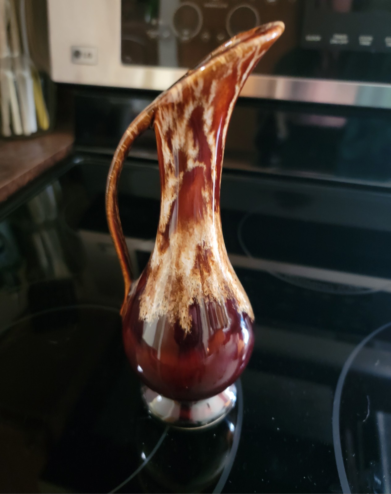 A mid-century American ceramic ewer with a brown and cream drip glaze.