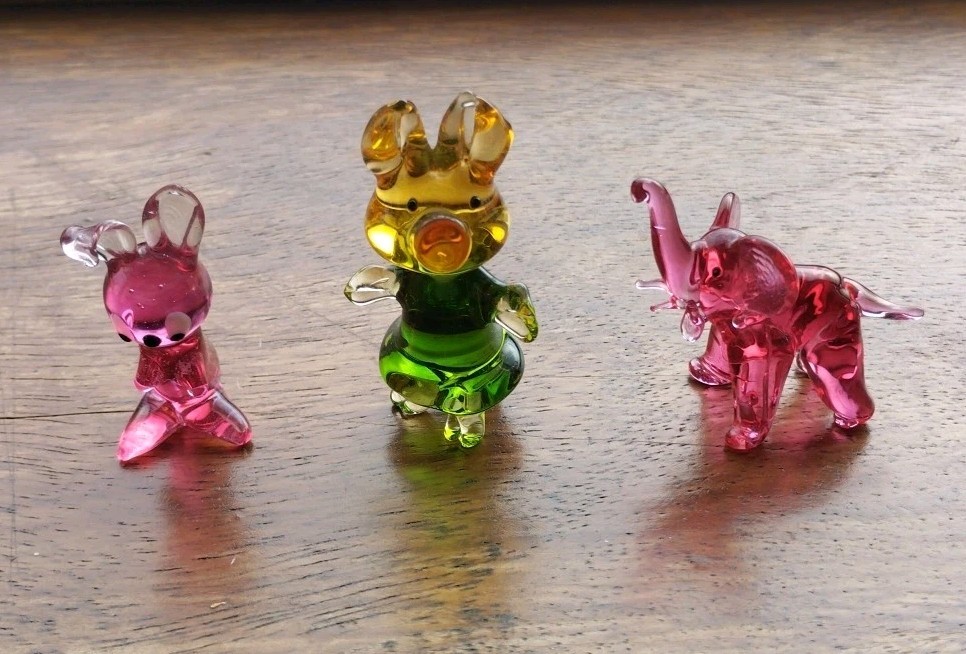 Vintage figurines of animals, stained glass decor. Hare, baby elephant, pig.