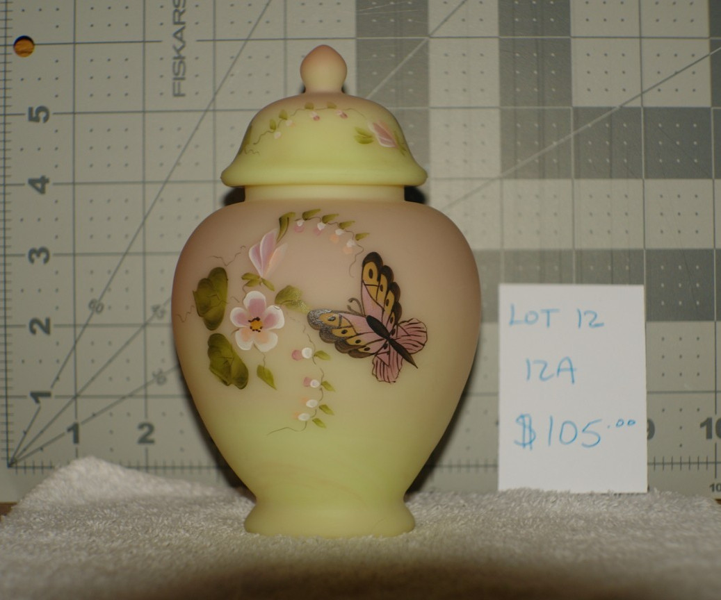 Fenton Burmese flowers with butterfly 6in jar with chipped piece on lid
