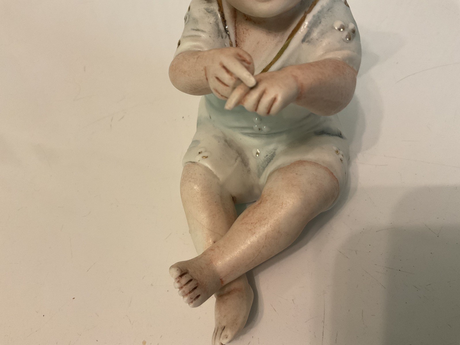 Antique German Bisque Porcelain Piano Baby Figurine Sitting 4 1/2 In tall