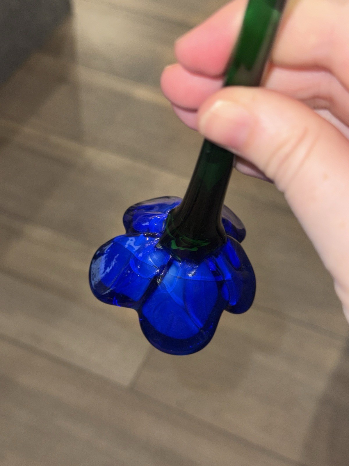 Hand-blown art glass flower with blue petals and a red center