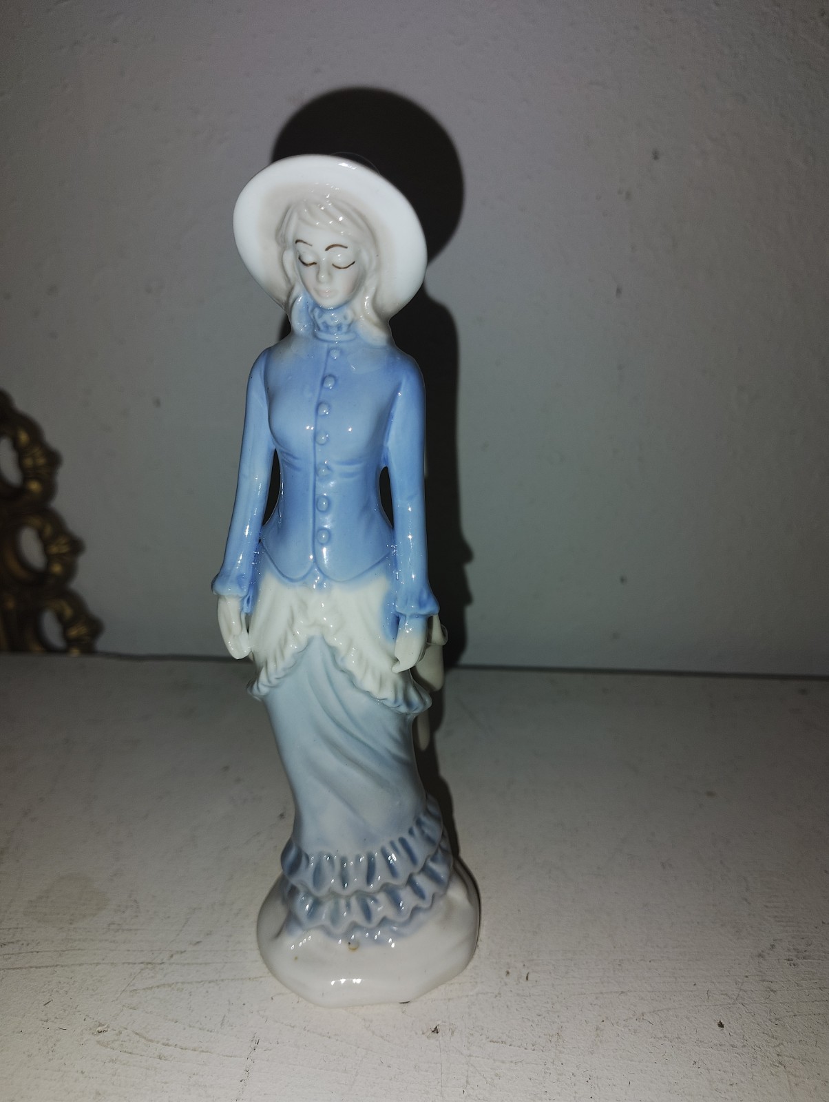 Vintage Porcelain woman figurine in blue dress and white hat