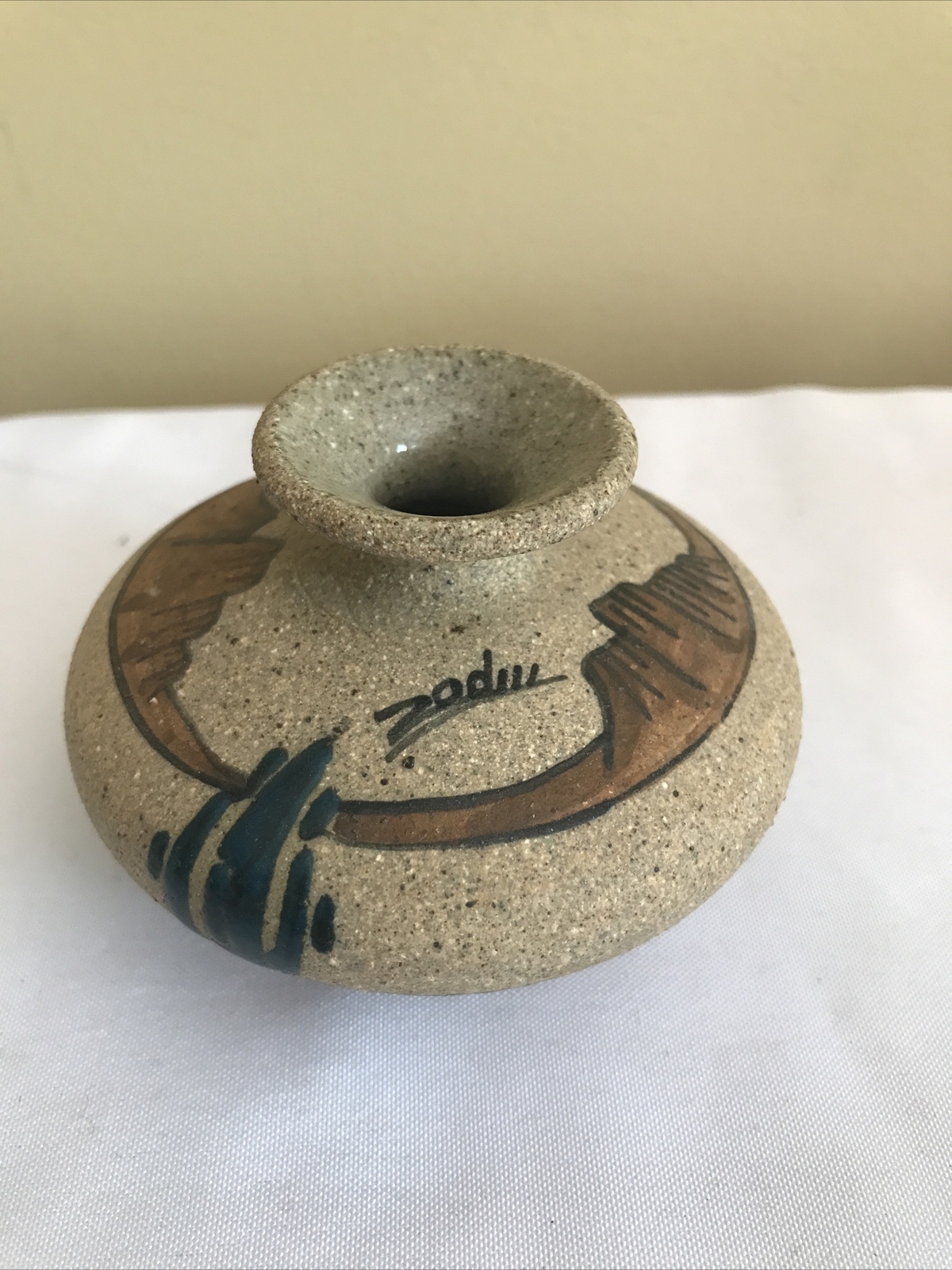 Small, artist-signed, Southwestern-style, pottery vase with inlaid cacti
