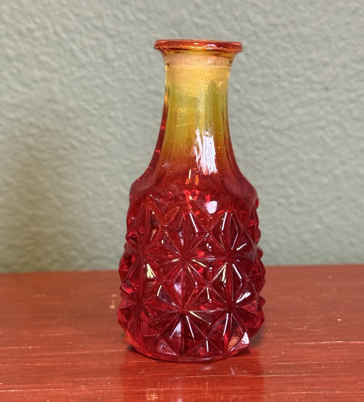 Vintage small red and amber hobnail glass bottle.