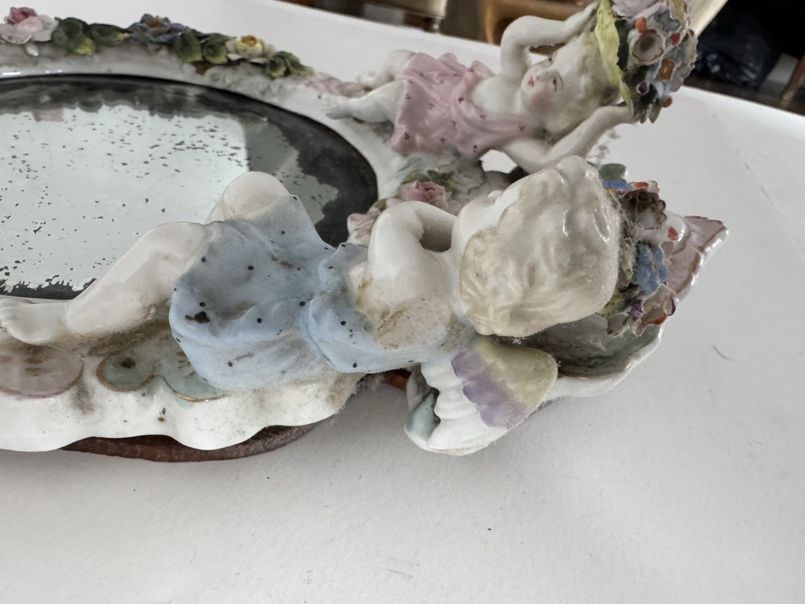 Antique Meissen porcelain mirror with original glass. Decorated with putti.