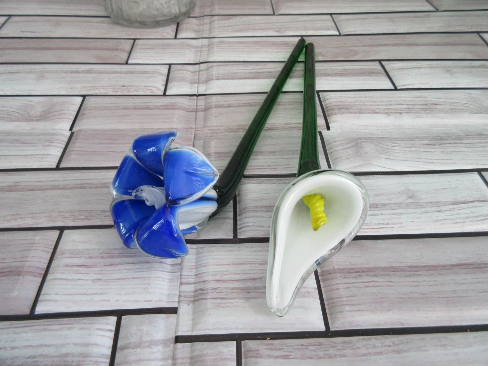 2 glass flowers 9nches with Green stems One white and one blue and white