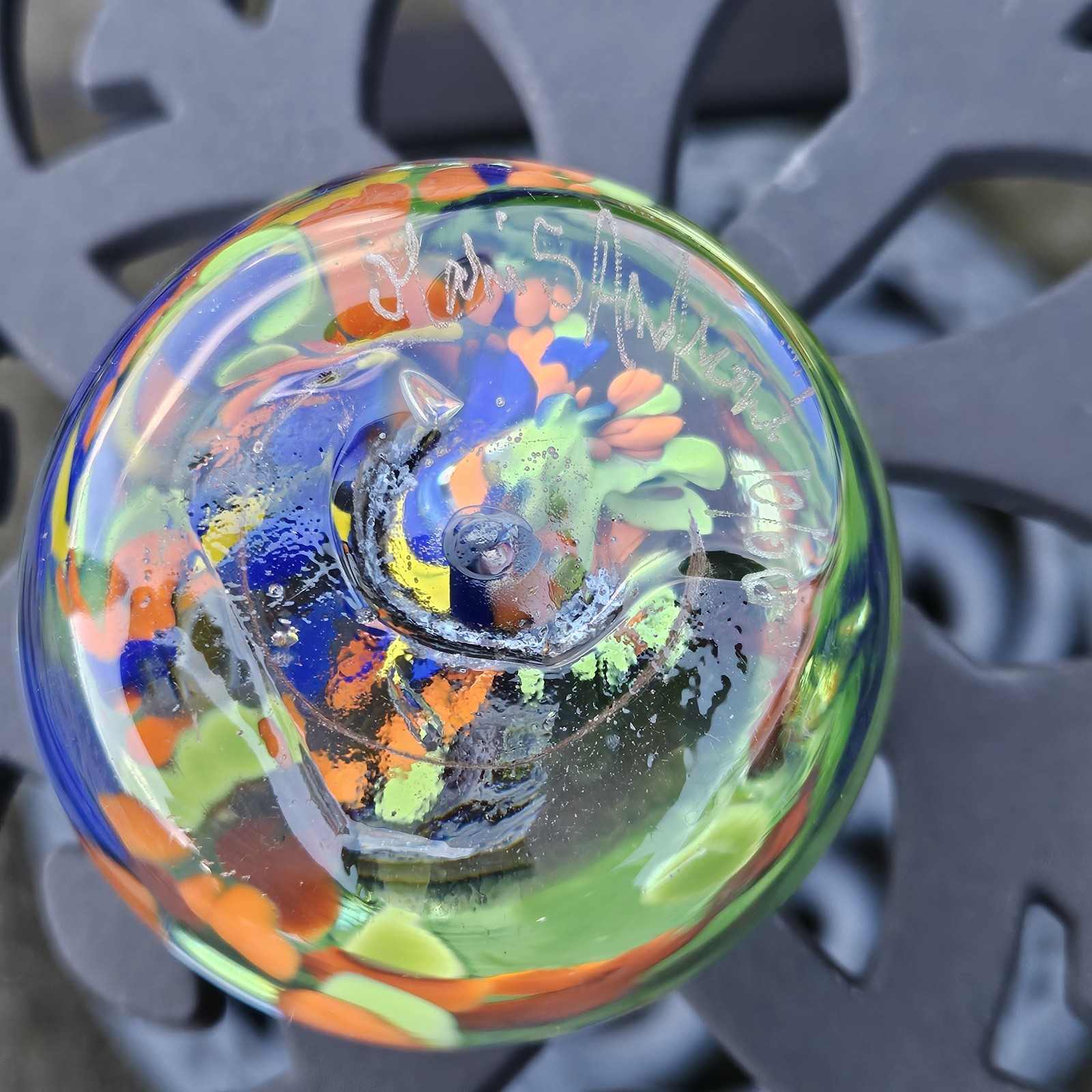 Signed Paperweight With Blue, Orange, And Green Flower with Controlled Bubble