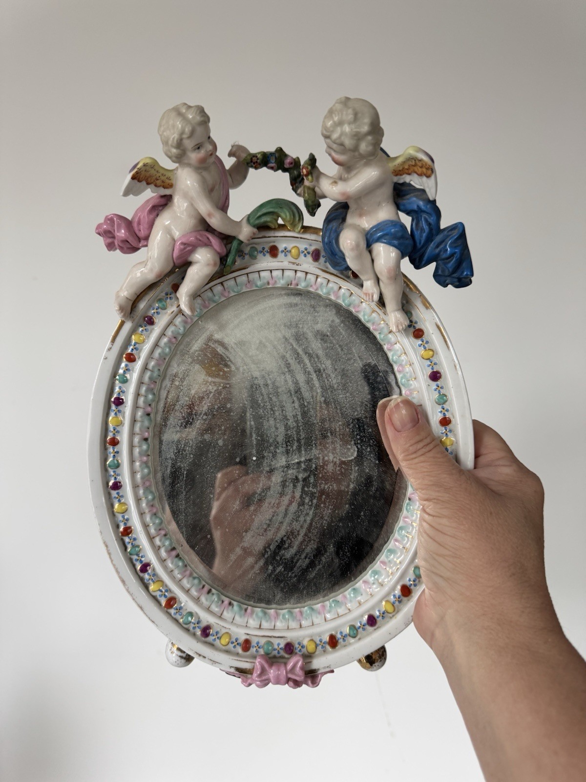 Antique Meissen porcelain mirror with original glass. Decorated with putti.