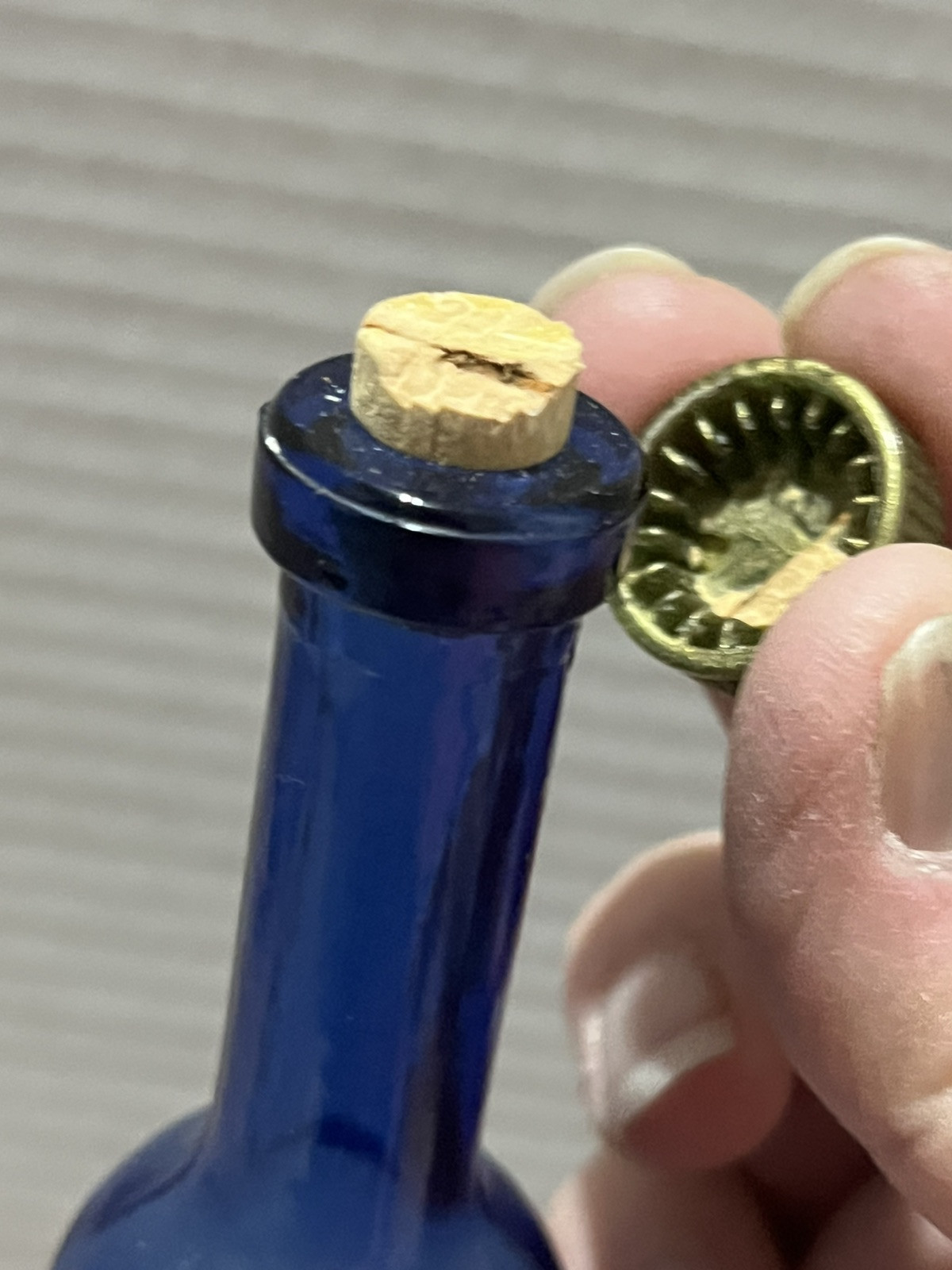 8.5″ Tall x 1.5″ Cobalt Blue bottle – plastic cap w/cork – Coat of Arms, Signed