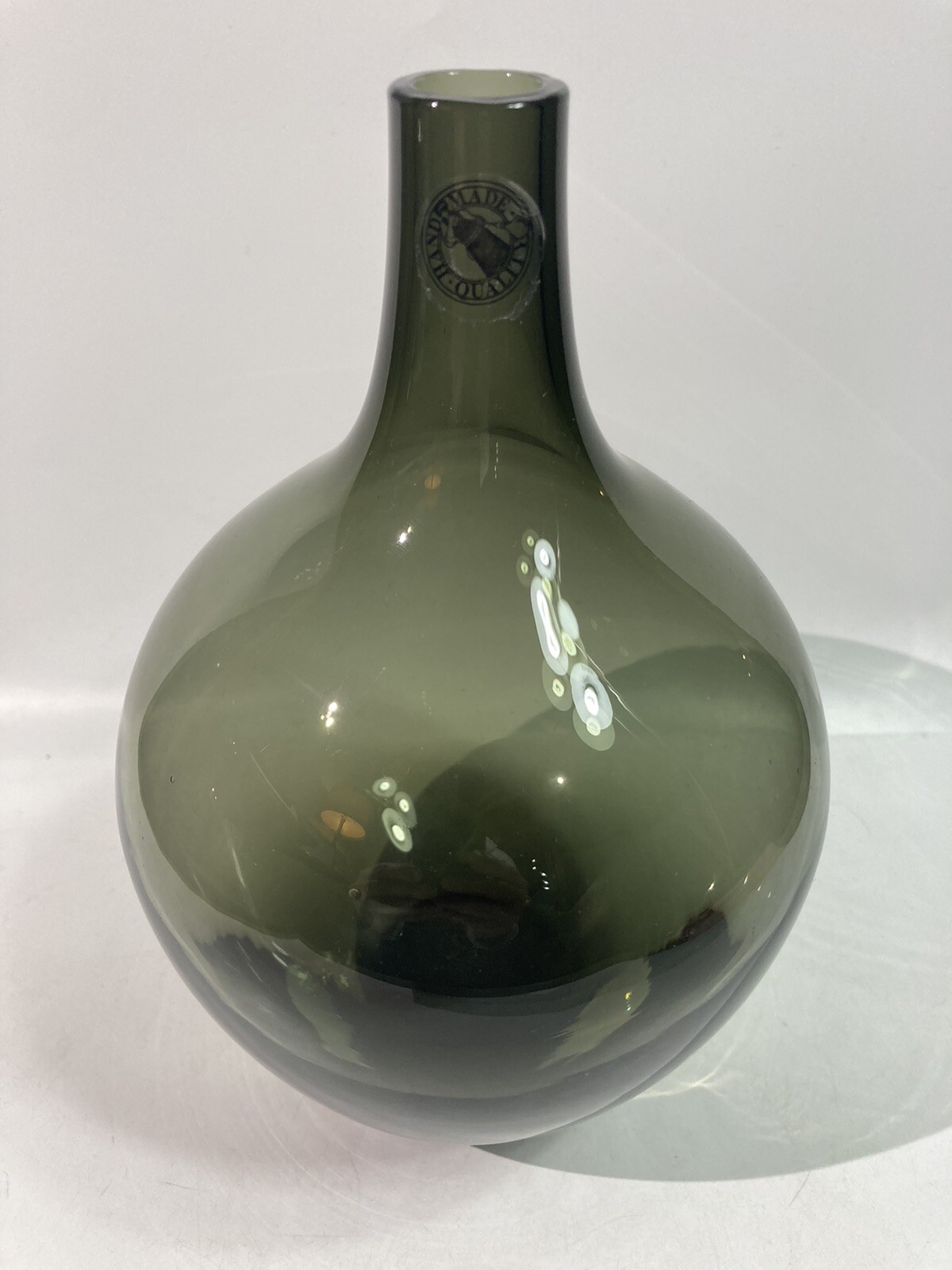 Hand-blown smokey gray glass bud vase modern rounded shape clear bottom label