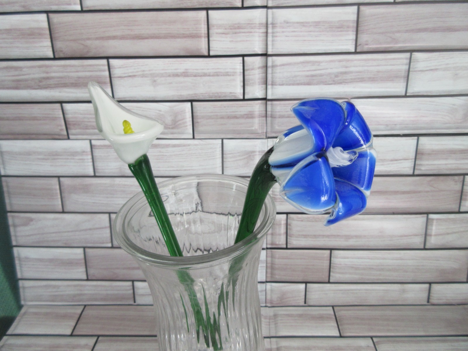 2 glass flowers 9nches with Green stems One white and one blue and white