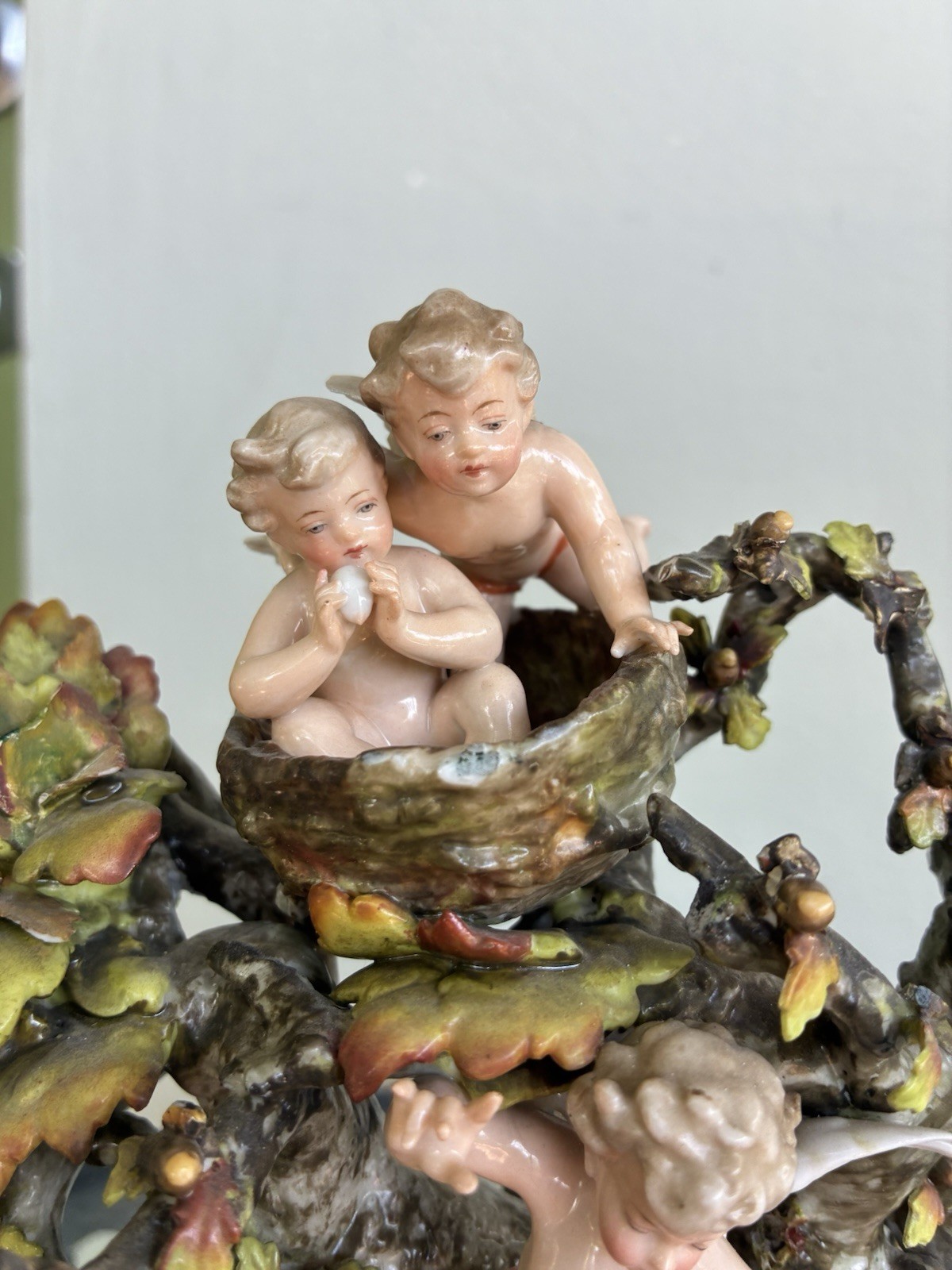 Volkstedt cherubs dancing in a tree and birds nest. 10” tall