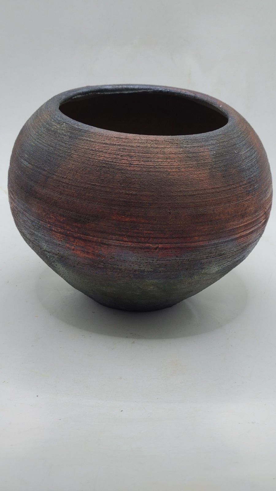 Raku pottery in iridescent metallic colors. Gorgeous piece. Signed.