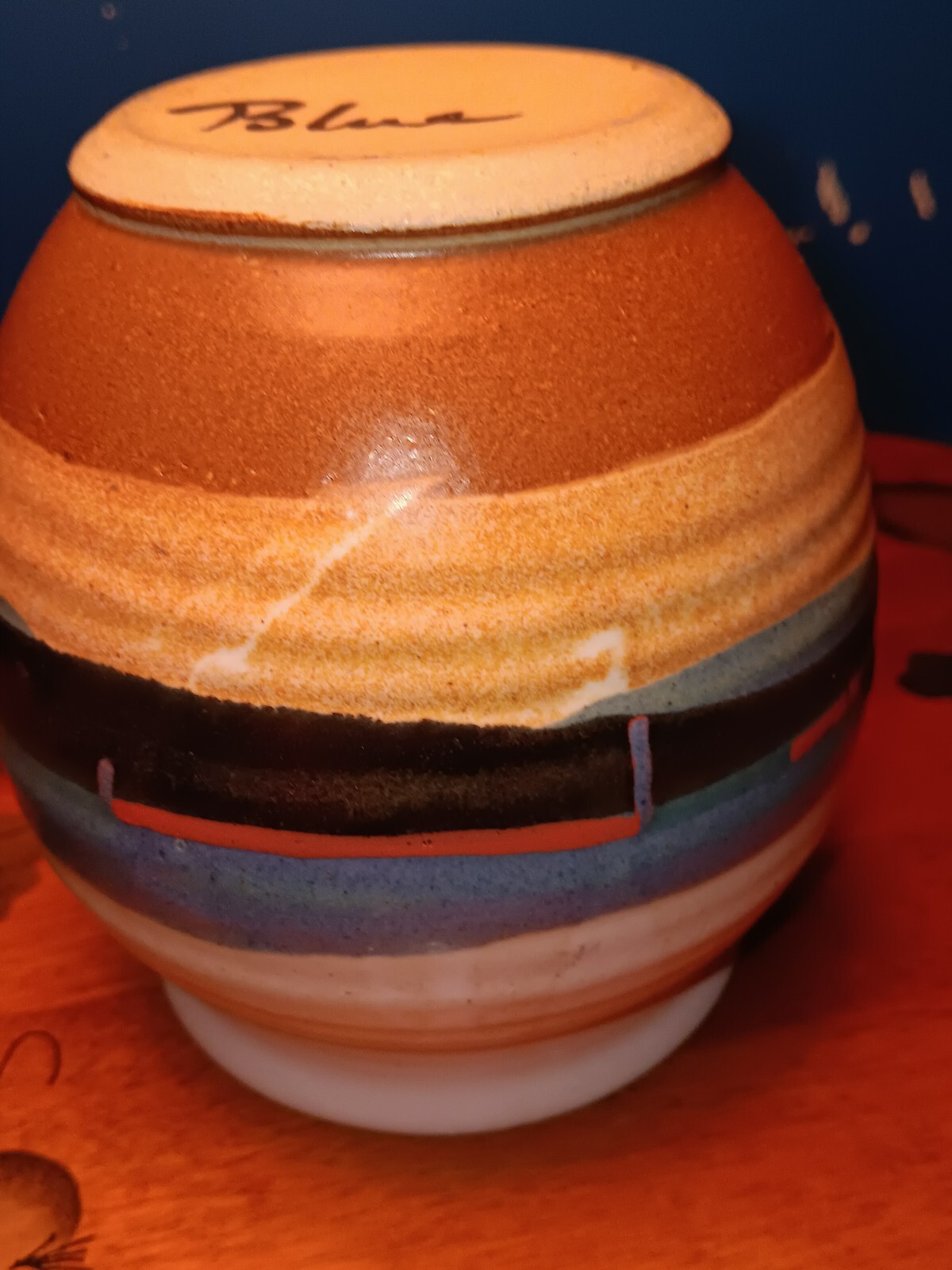 Pottery Artist Signed Blue. White blue red black tan brown, Round the vase.