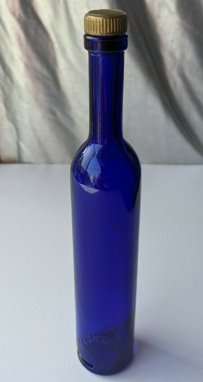 COBALT BLUE THIN CORKED BOTTLE. COAT OF ARMS SIGNED