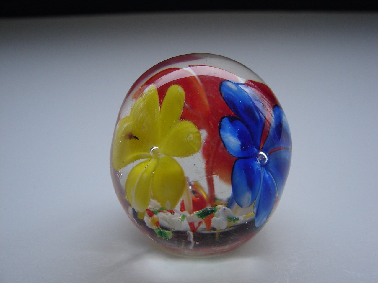 Small Blown Art Glass Paperweight With Red Yellow And Blue Flowers