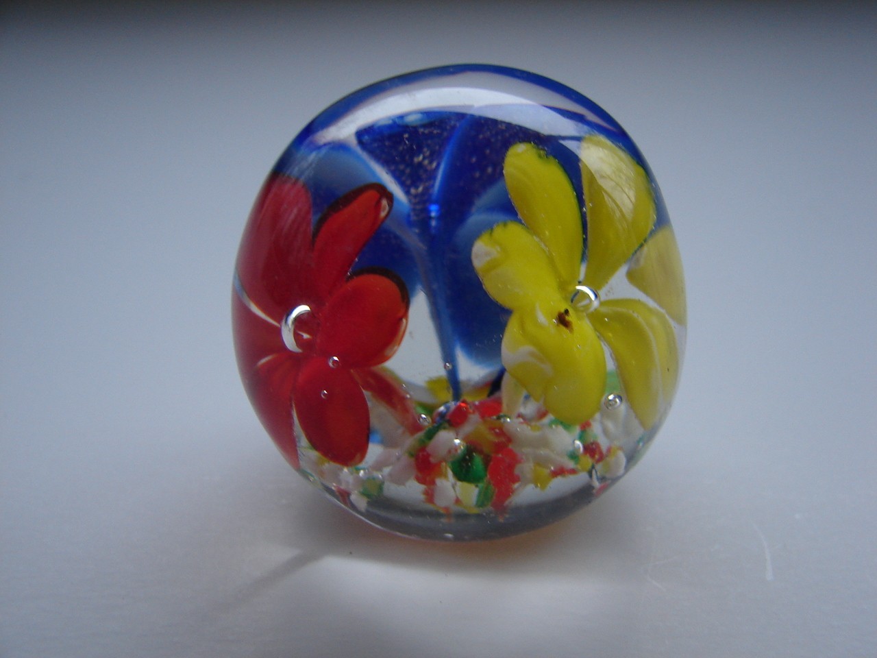 Small Blown Art Glass Paperweight With Red Yellow And Blue Flowers
