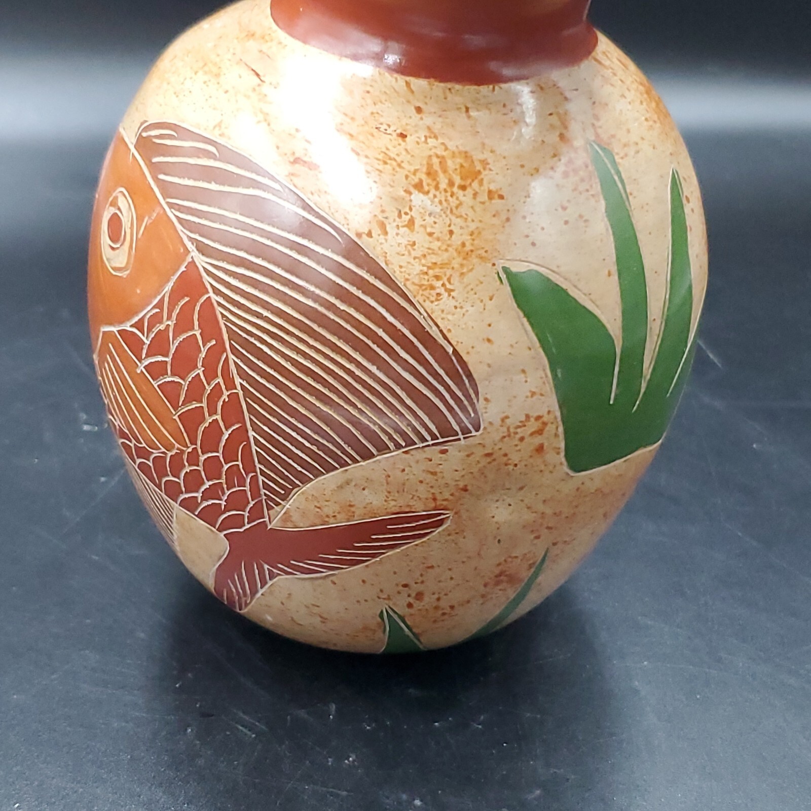 Handmade nicaraguan carved pottery vase with fish. 4.5 inches tall, approx 1.5