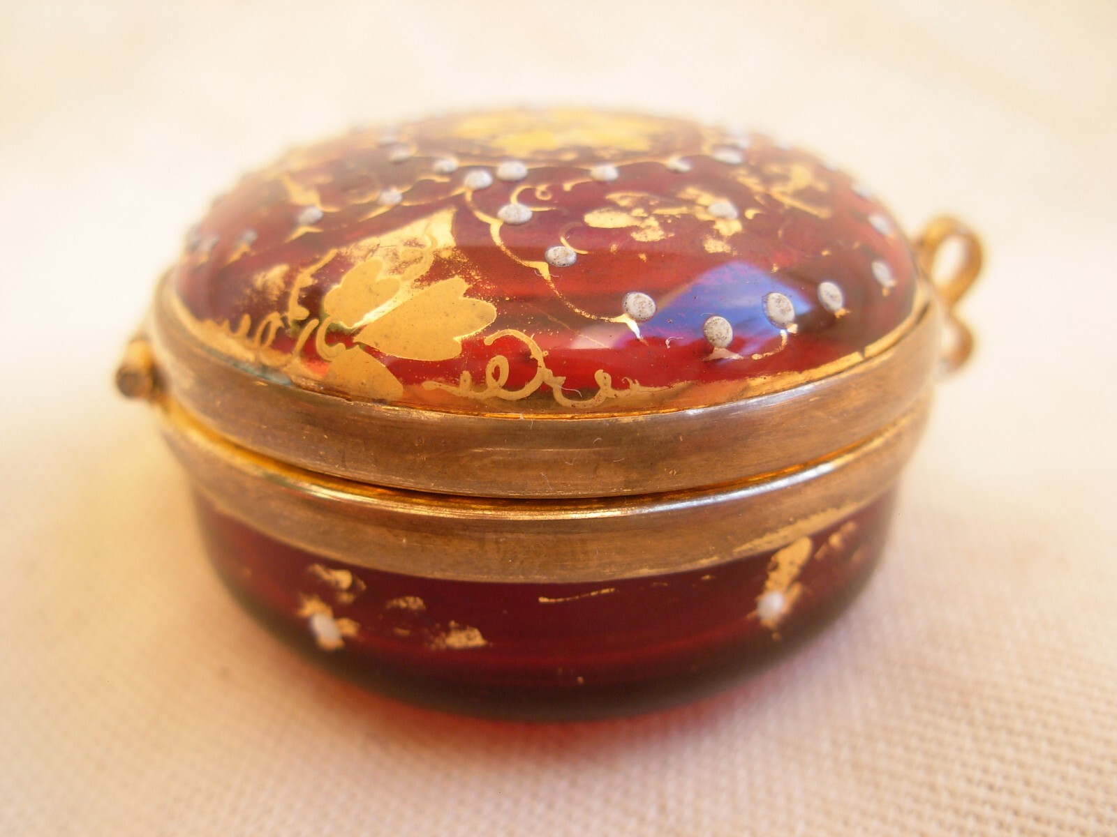 ANTIQUE BOHEMIAN ENAMELED RED GLASS PILL BOX WITH GILT BRASS MOUNT,LATE 19th.