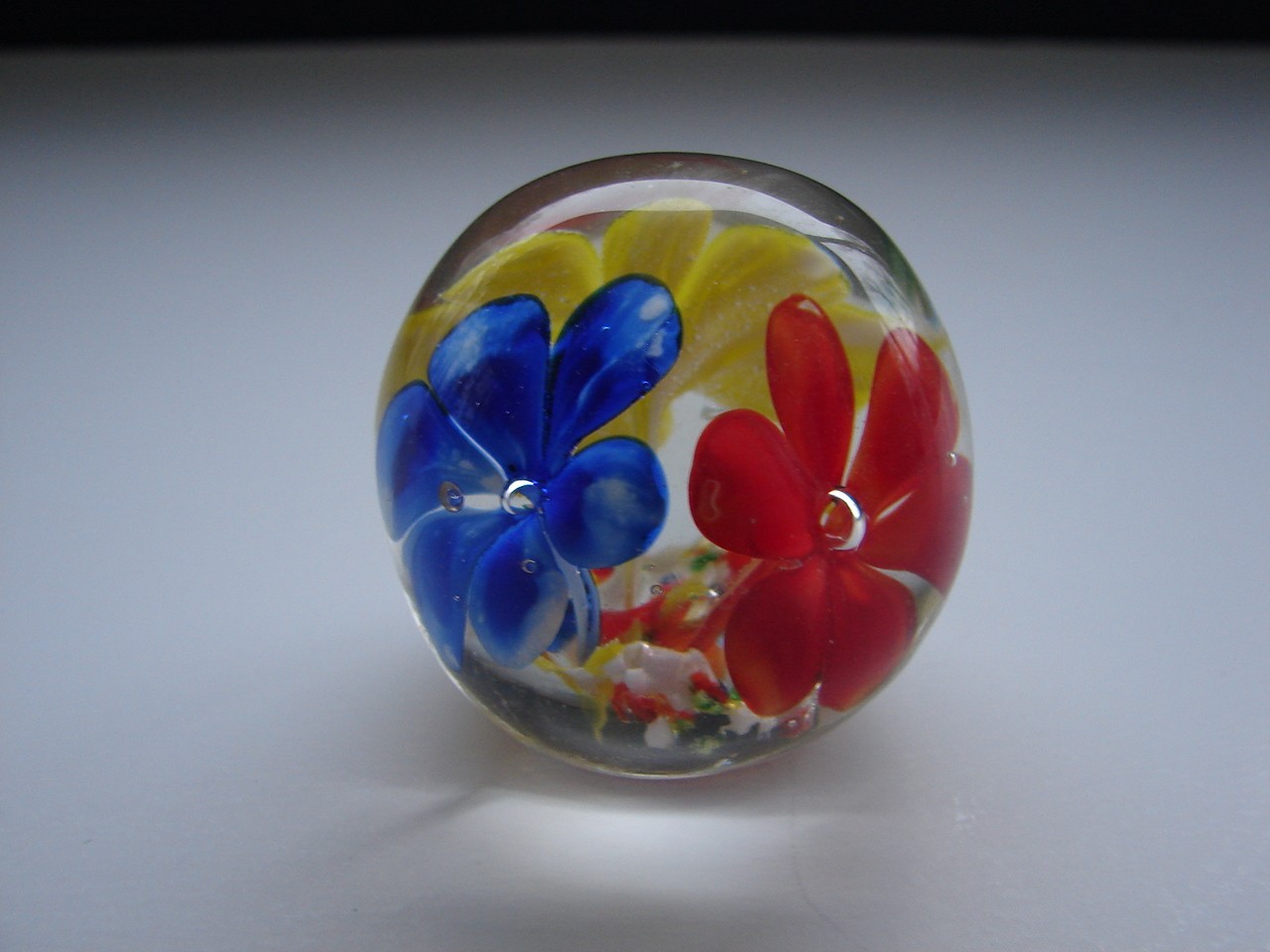 Small Blown Art Glass Paperweight With Red Yellow And Blue Flowers