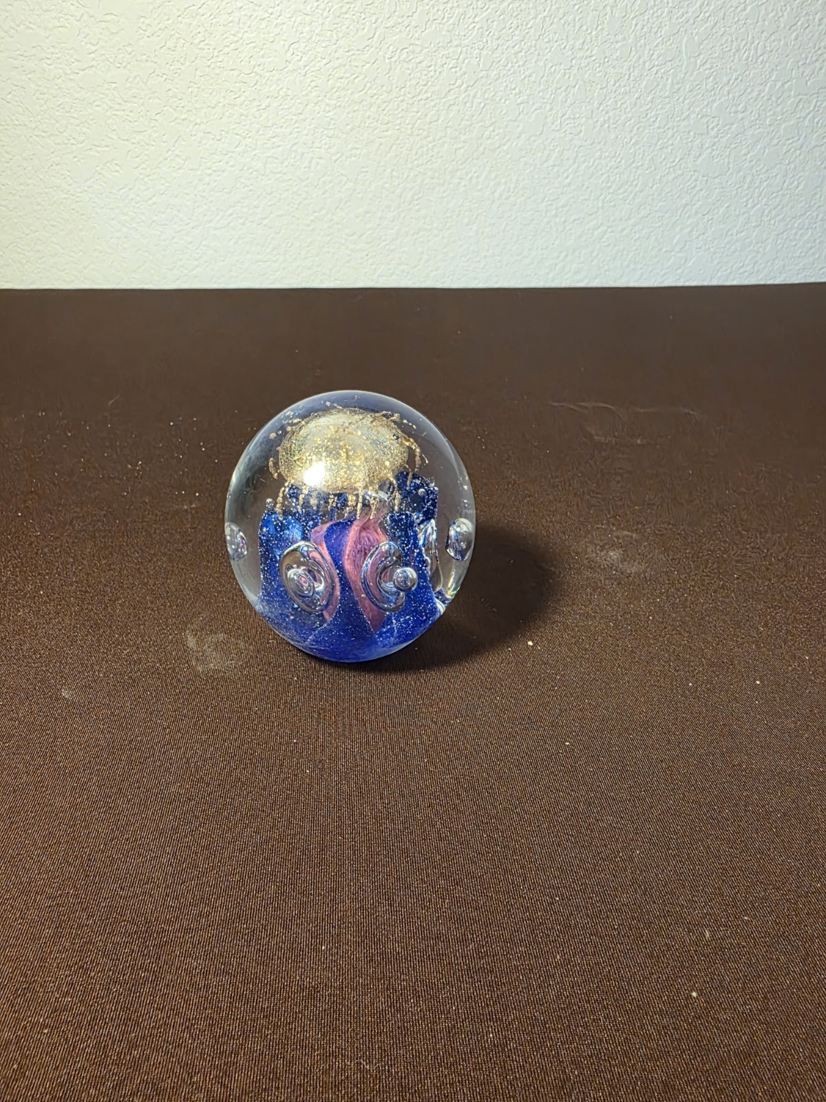 vintage hand-blown art glass paperweight features a gold cloud suspension