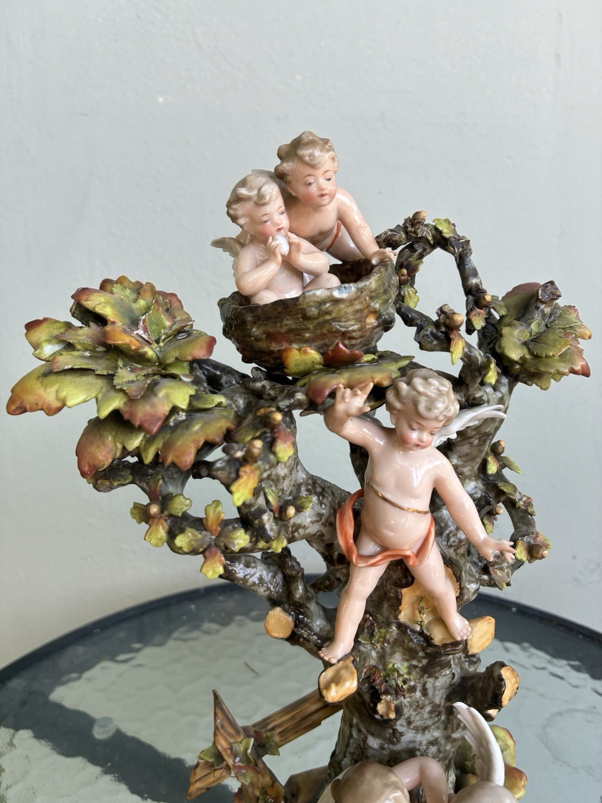 Volkstedt cherubs dancing in a tree and birds nest. 10” tall