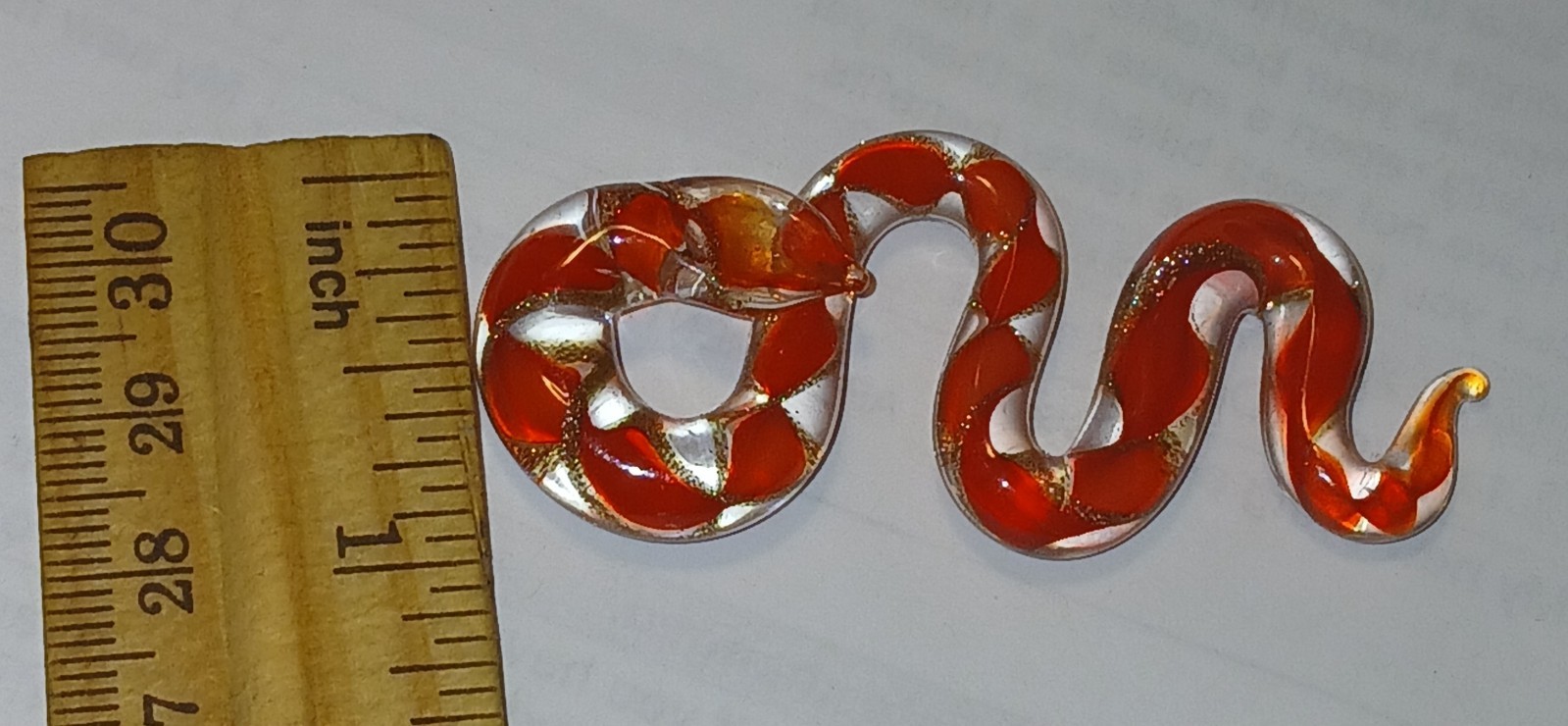 Blown glass snake – clear with red& gold glitter twisted glass ribbon inside