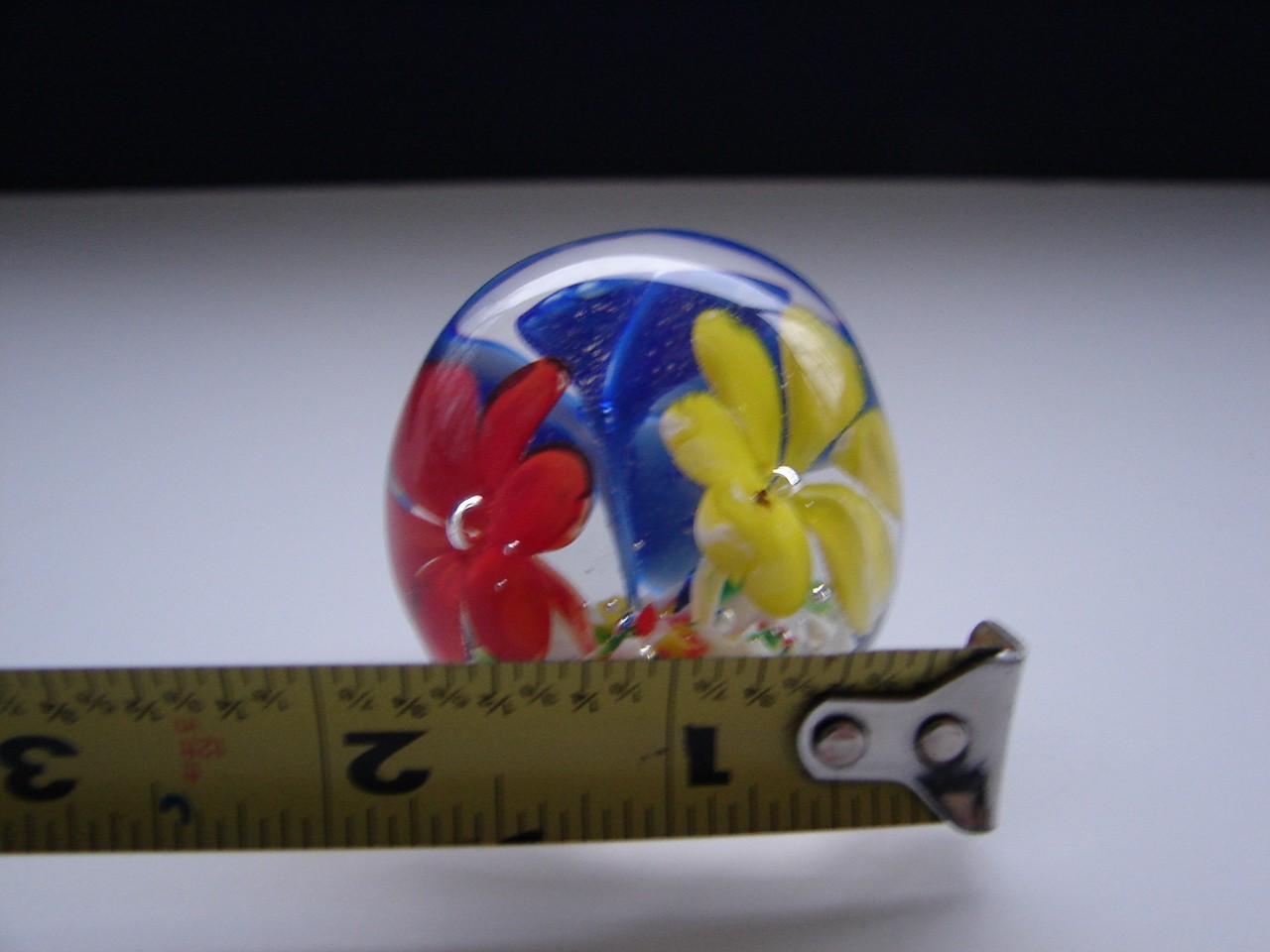 Small Blown Art Glass Paperweight With Red Yellow And Blue Flowers