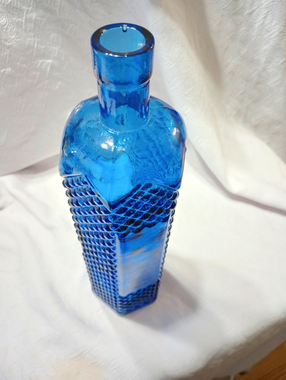 12 1/2″ Cobalt Bottle With Diamond Pattern And Clear Panels Around Center.
