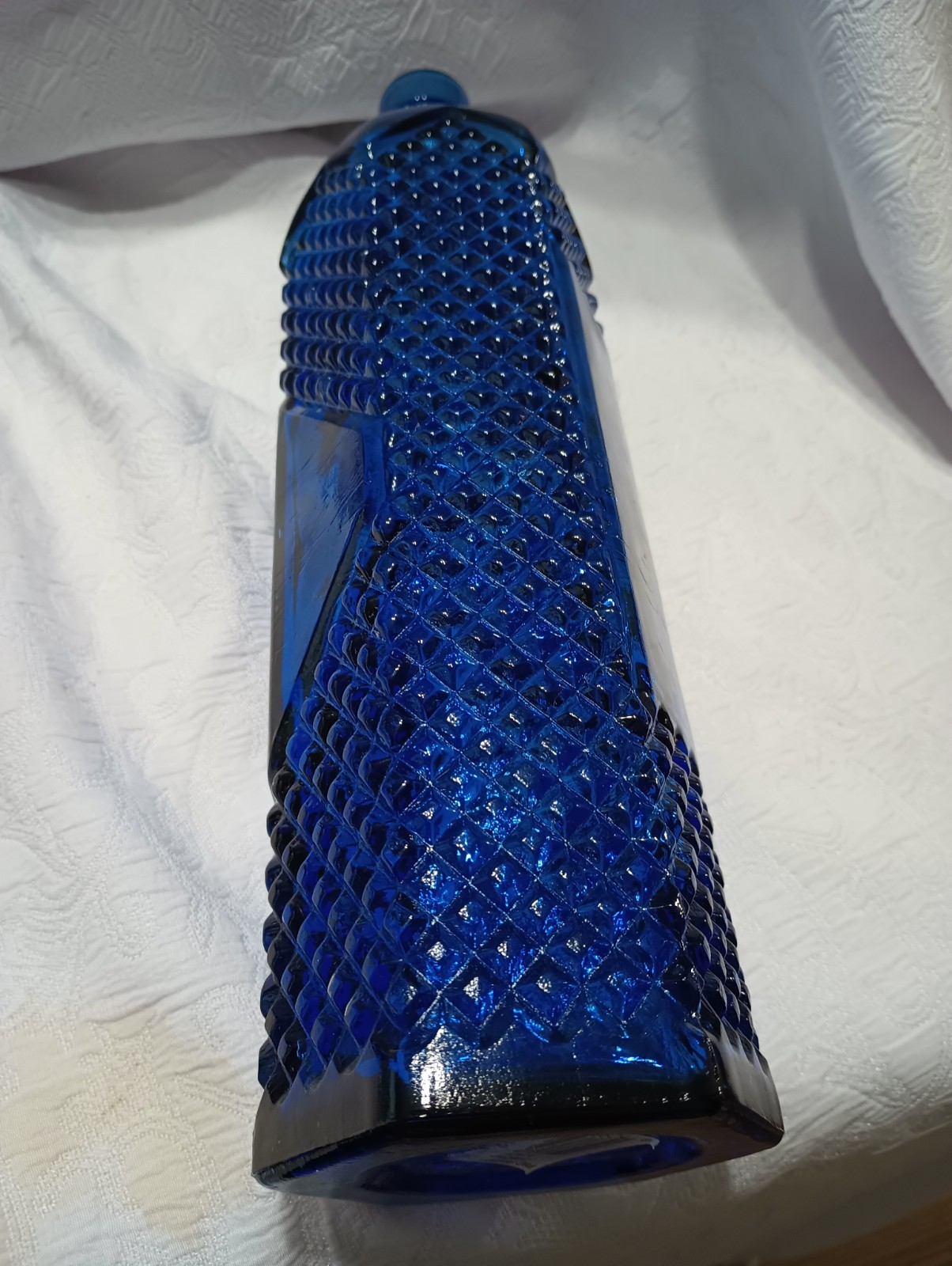 12 1/2″ Cobalt Bottle With Diamond Pattern And Clear Panels Around Center.
